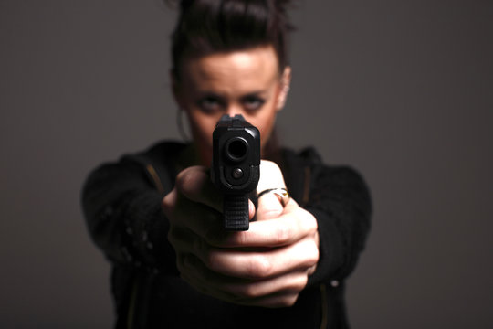 Young woman with a pistol.