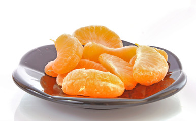 Fresh mandarin on the black  plate