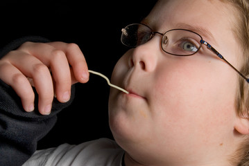 A young boy enjoying some very delicious spaghetti.