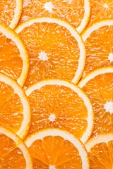 Foto op Plexiglas Achtergronddelen van sinaasappel door ringen. © Natalya Antoshchenko