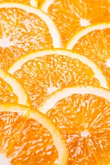 Foto op Canvas Achtergronddelen van sinaasappel door ringen. © Natalya Antoshchenko