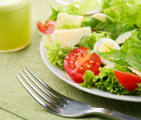 Fresh salad with tomato and quail eggs