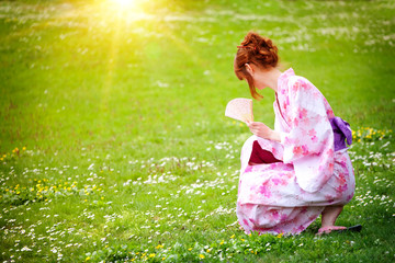 beautiful young woman in a Kimono in the Gardens