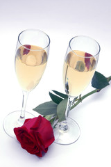 Copas de champagne y rosa roja