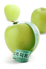 green apple with measuring tape