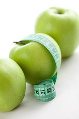 green apple with measuring tape