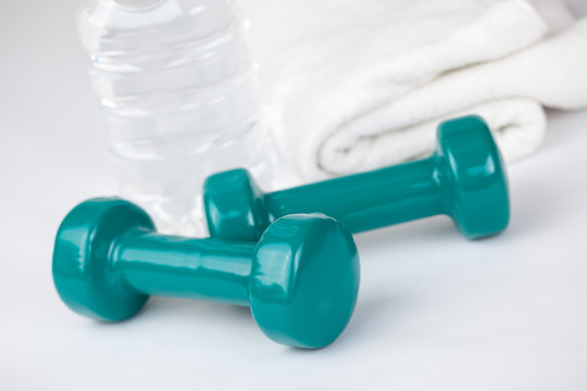 dumbells with towel and water