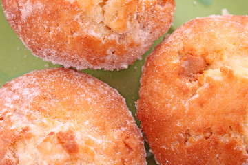 Three cupcakes on green  background