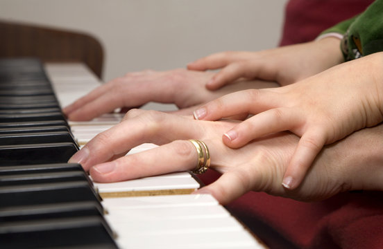 hands of piano player and the child