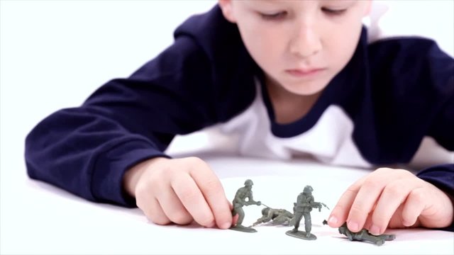 Boy Playing with Toy Soldiers