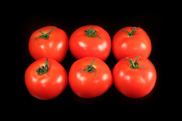 Tomatoes on black background