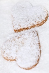 two heart shaped cookies on sugar
