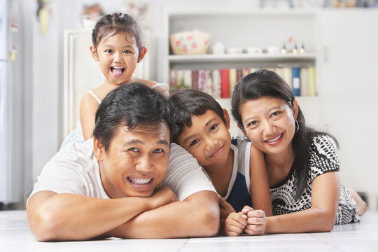 Asian Family Posing On The Floor