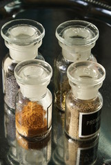 Spices, poppy seed, into jars of chemicals, are on a tray