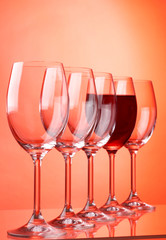 Wine glasses on red background..
