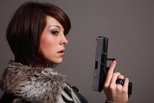 young fashionable woman with a pistol