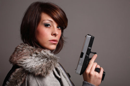 young fashionable woman with a pistol