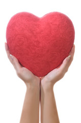 Red heart in female hands
