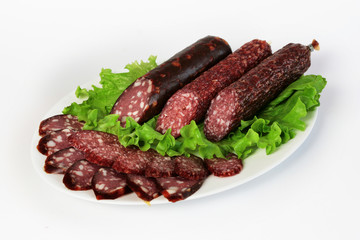 three sausage with salad on a plate