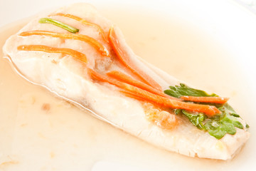 Steamed fish with carrot on top