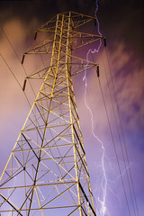 Electricity Pylon with Lightning in Background.
