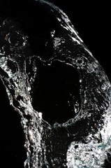 Stylish water splash. Isolated on black background .