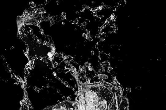 Stylish water splash. Isolated on black background .