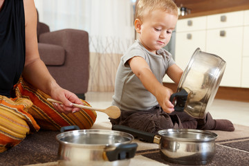 Little boy playing in kitchen