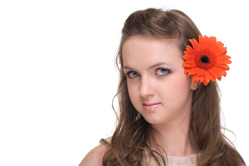 Close up portrait of young beautiful woman with  orange flower