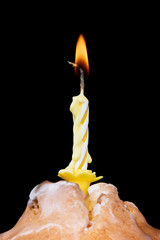cupcake with candle isolated on black background