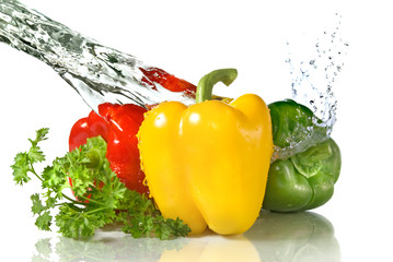 red, yellow, green pepper and parsley with water splash