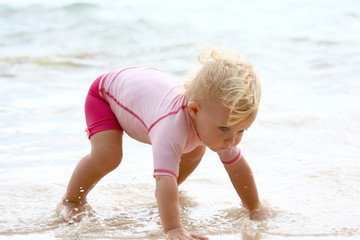 baby crawling in water