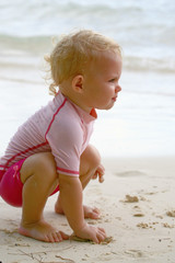 Fototapeta na wymiar baby grabbing sand
