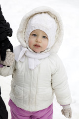 portrait of serious little girl in winter clothes