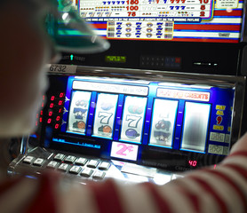Young Woman Playing Slot Machine
