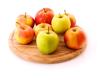 Few apples on wooden tray isolated on white