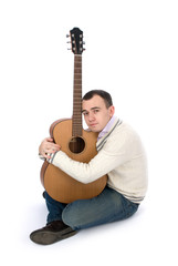 man playing his acoustic guitar