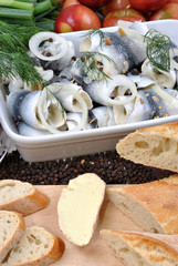 some fresh organic rollmops on a white plate