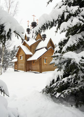 wooden church on a snowy meadow