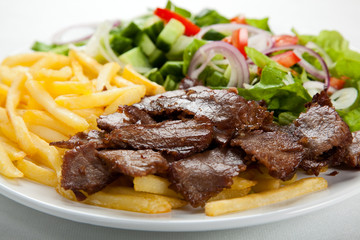 Grilled meat with fried potatoes and vegetables