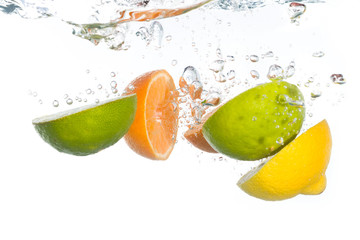 Fototapeta na wymiar Citrus fruit falling into clear water