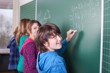 schulkinder rechnen an einer tafel