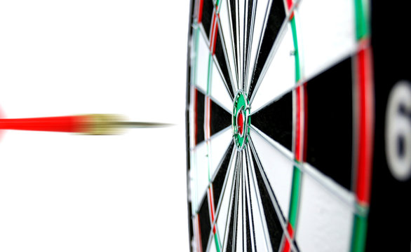 Dartboard with flight of dart on the bullseye