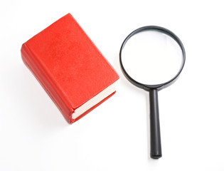 Book and magnifying glass isolated on the white background