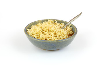 Chili flavored noodles in old stoneware bowl with spoon