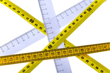 tape measures cross on white background