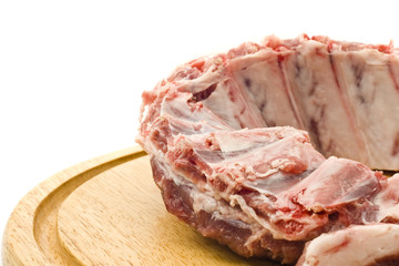 Pork ribs with raw meat on round hardboard