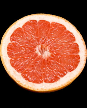 Half grapefruit on black background