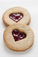 two linzer cookies with heart shape raspberry jam window