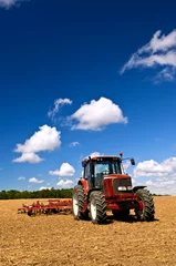Poster Tractor in plowed field © Elenathewise